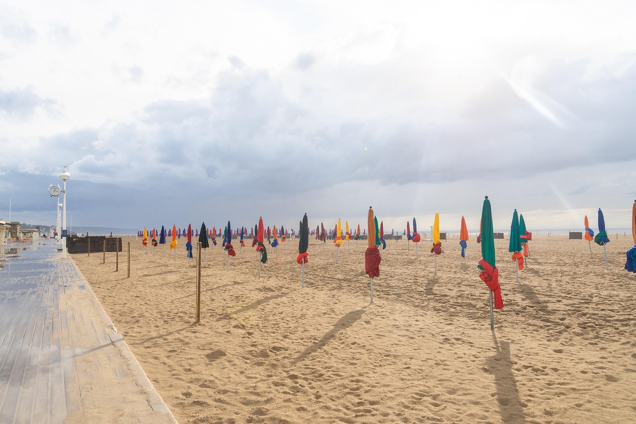 Deauville beach with parasols and the boardwalk