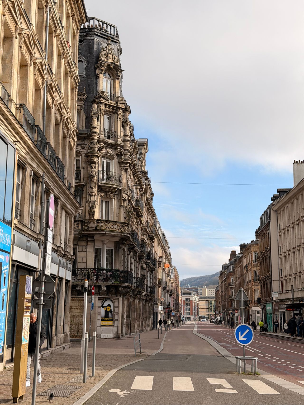 Historic street in Rouen with half-timbered houses under a clear spring sky